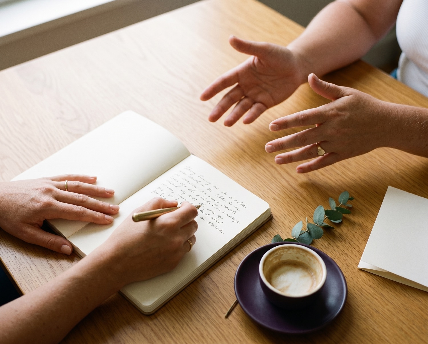 Hands sketching out strategy notes over coffee